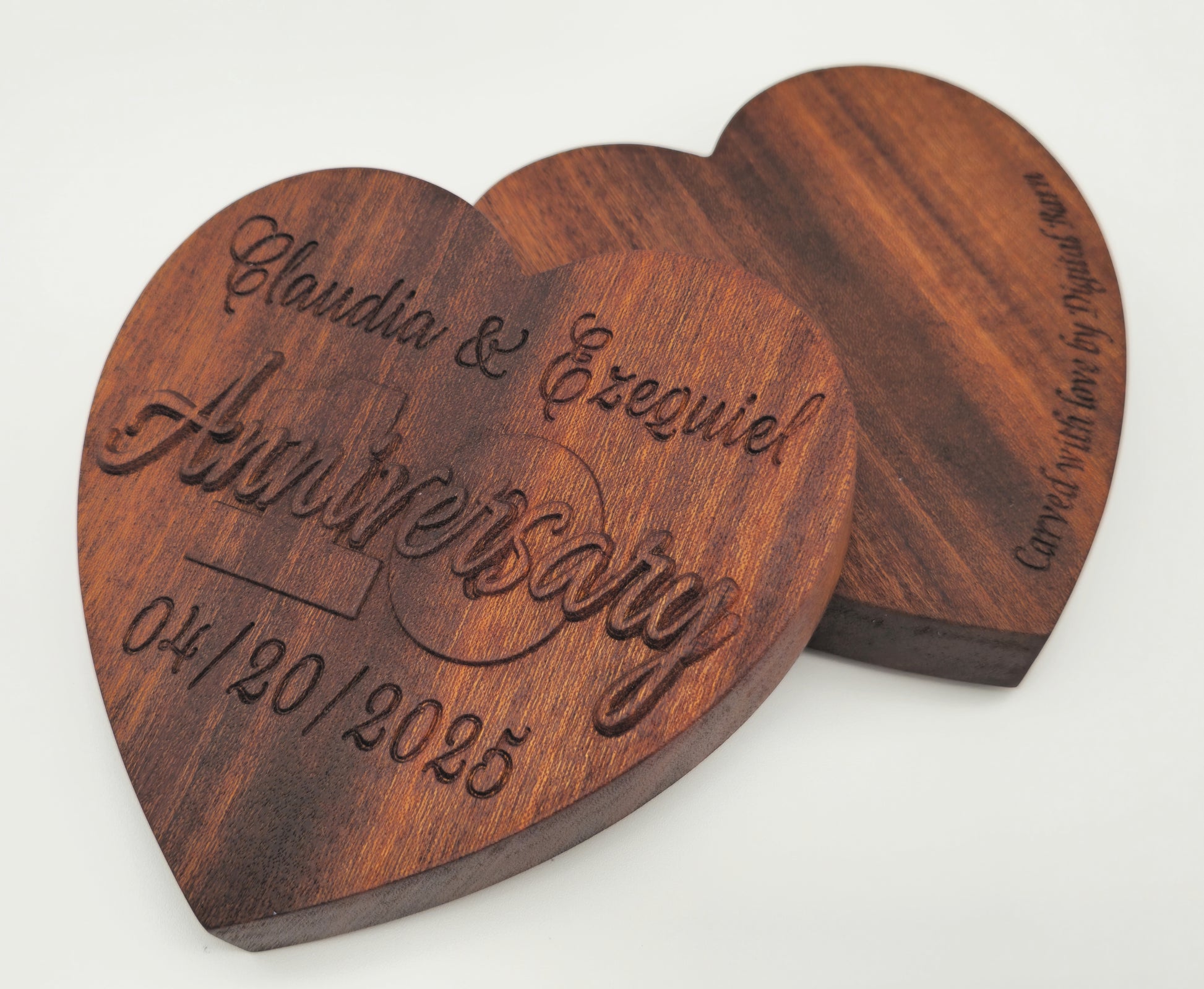Wooden heart-shaped Jewelry box with engraved text on a white background