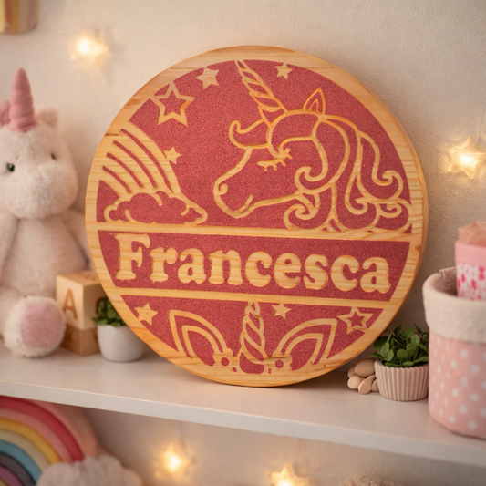 Decorative wall art with a unicorn design and the name 'Francesca' on a shelf with decorative items.