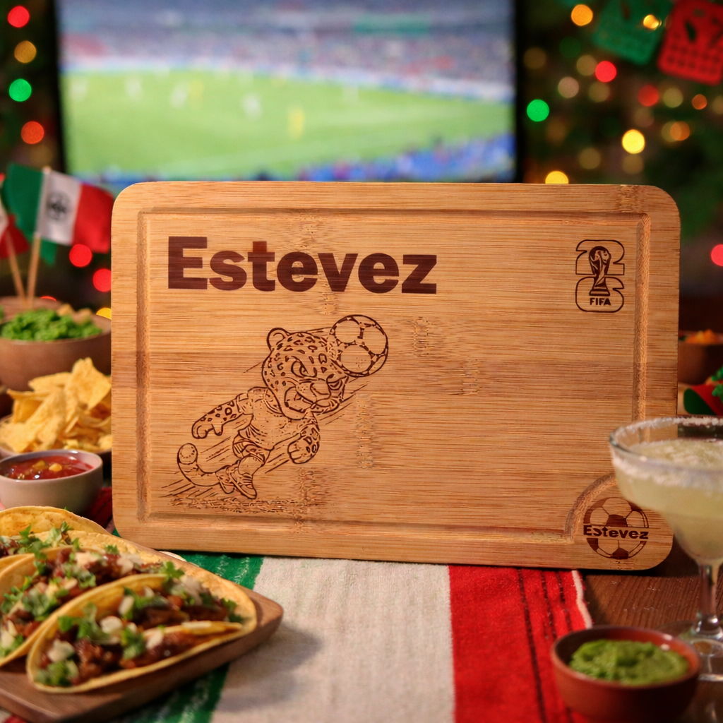 Wooden cutting board with 'Estevez' branding and a soccer-themed design, placed on a table with food and drinks.
